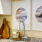 a kitchen sink with pictures on the wall