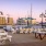 Outdoor lounge at our apartments for rent in Stamford, CT, featuring adirondack chairs, a fire pit, and a view of the docks.