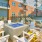 Outdoor lounge at our apartments for rent in Stamford, CT, featuring adirondack chairs and umbrellas surrounding a fire pit.