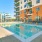The pool area at our apartments for rent in Stamford, CT, featuring beach chairs and a view of the apartment community..