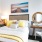 a bedroom with a bed, desk, and a chair