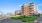 The exterior of the Harbor Landing apartment building in Stamford, CT, featuring a brick facade and public sculpture.