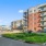 The exterior of the Harbor Landing apartment building in Stamford, CT, featuring a brick facade and public sculpture.