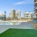 The pool area at our apartments for rent in Stamford, CT, featuring beach chairs, a pool, and astroturf.